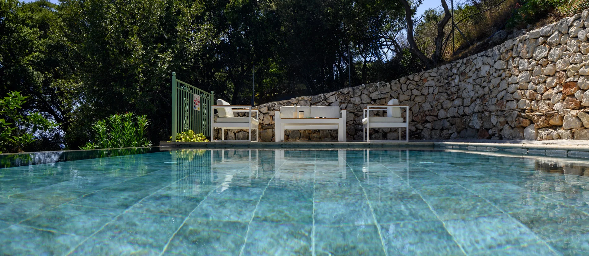 Villa with Large infinity pool with sun loungers, umbrellas, and outdoor seating